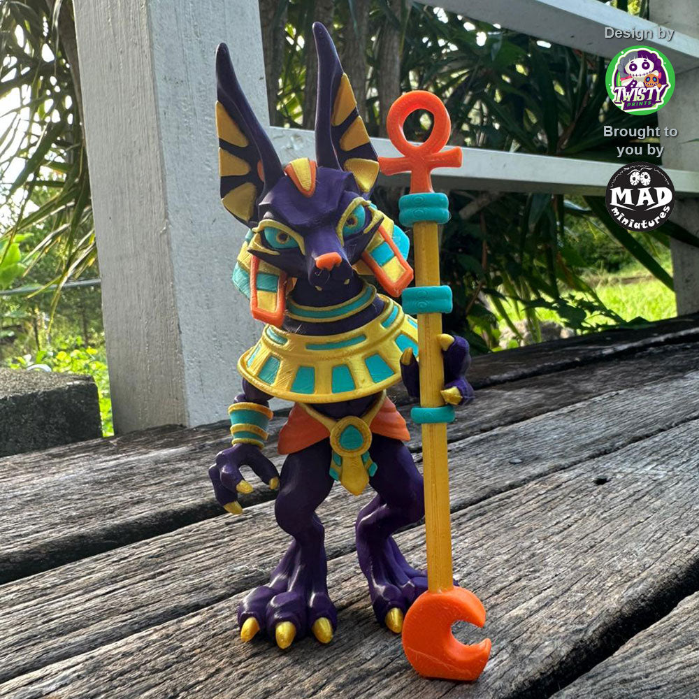 Articulated Anubis figure standing on a wooden deck, holding a staff