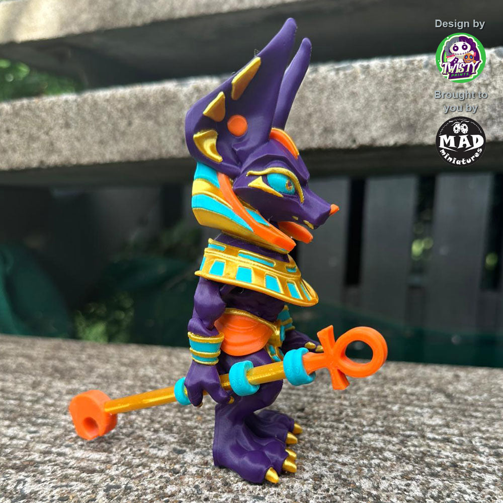 Side view of the articulated Anubis figure holding a staff