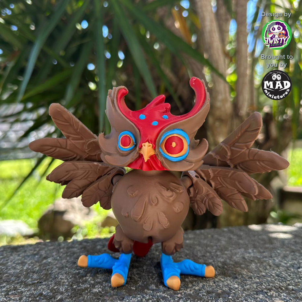 Close-up of the Creepy Owl with hypnotic eyes, showcasing its dark brown body, maroon accents, and blue legs. The wings and head are poseable