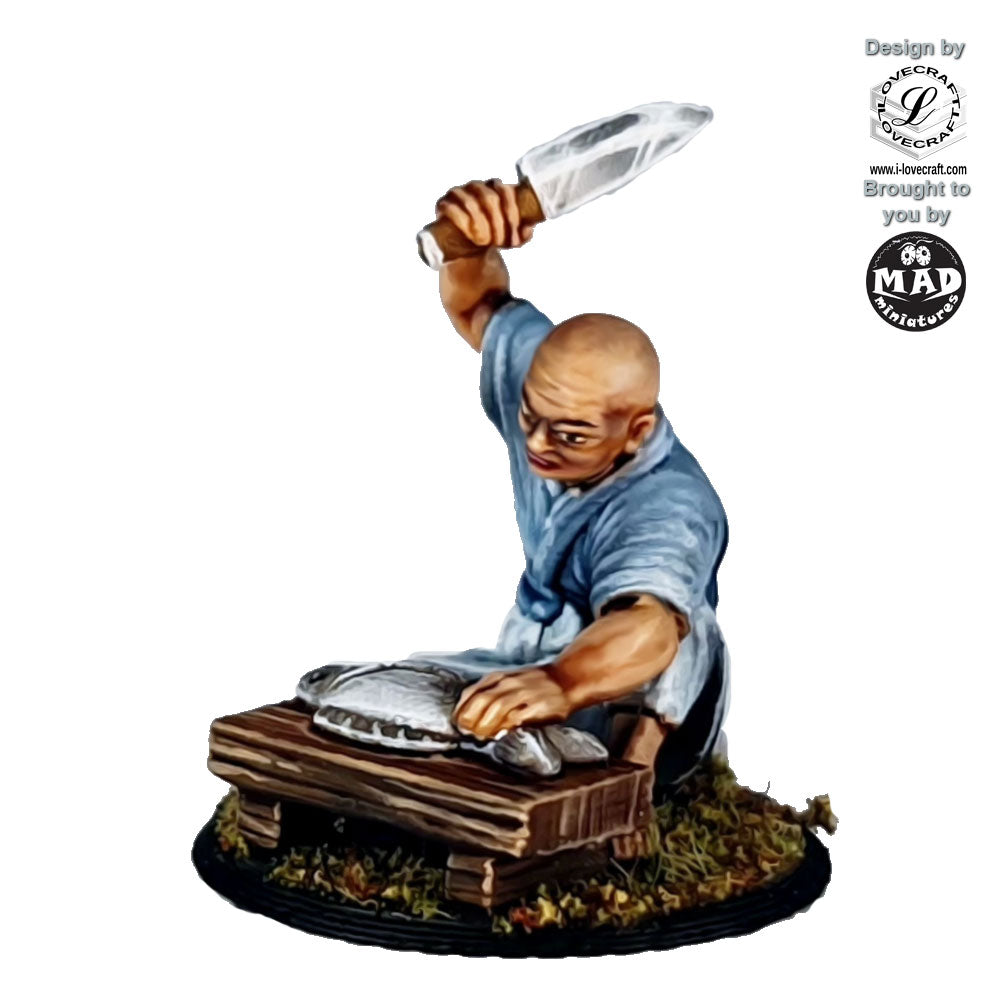 28mm miniature of an Edo-period fisherman kneeling at a wooden table, holding a knife above a fish, designed for tabletop gaming and dioramas.
