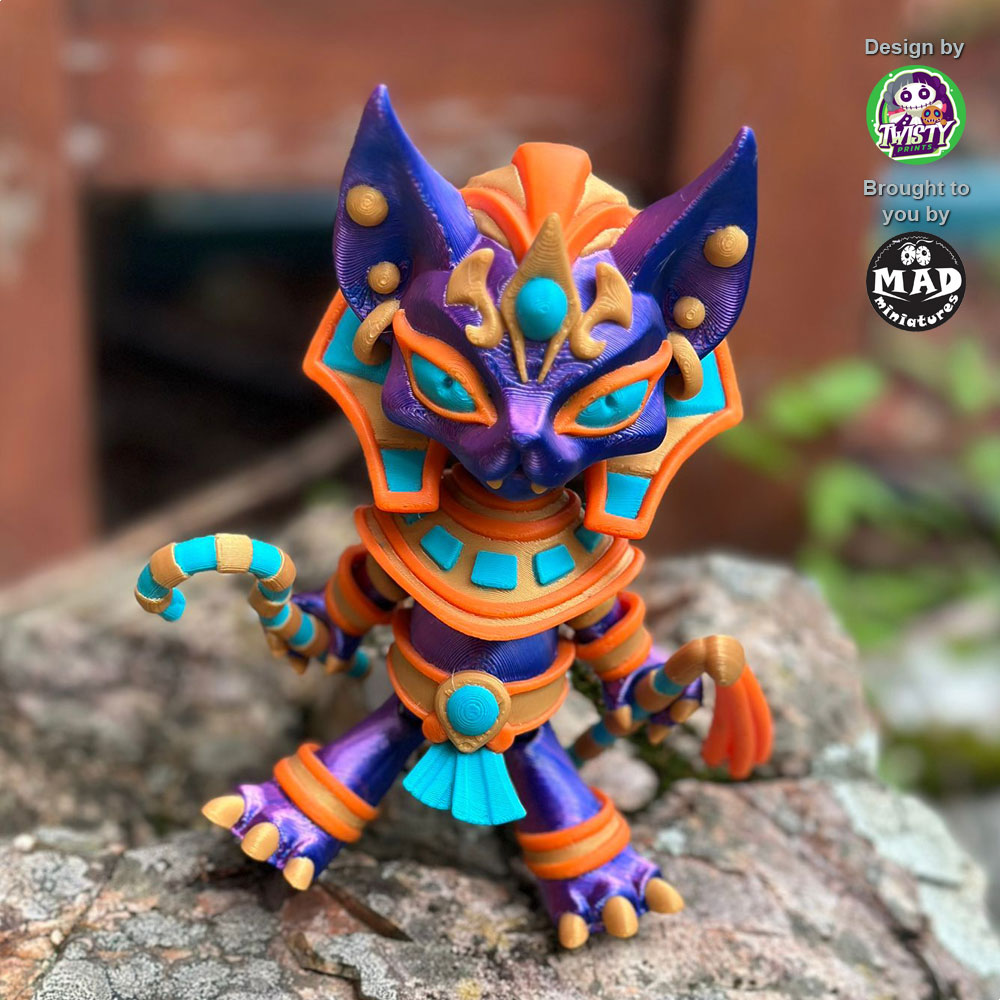 Pharaoh Cat in action, showing off her shimmering blue-purple coat, golden Egyptian attire, and vibrant staffs.