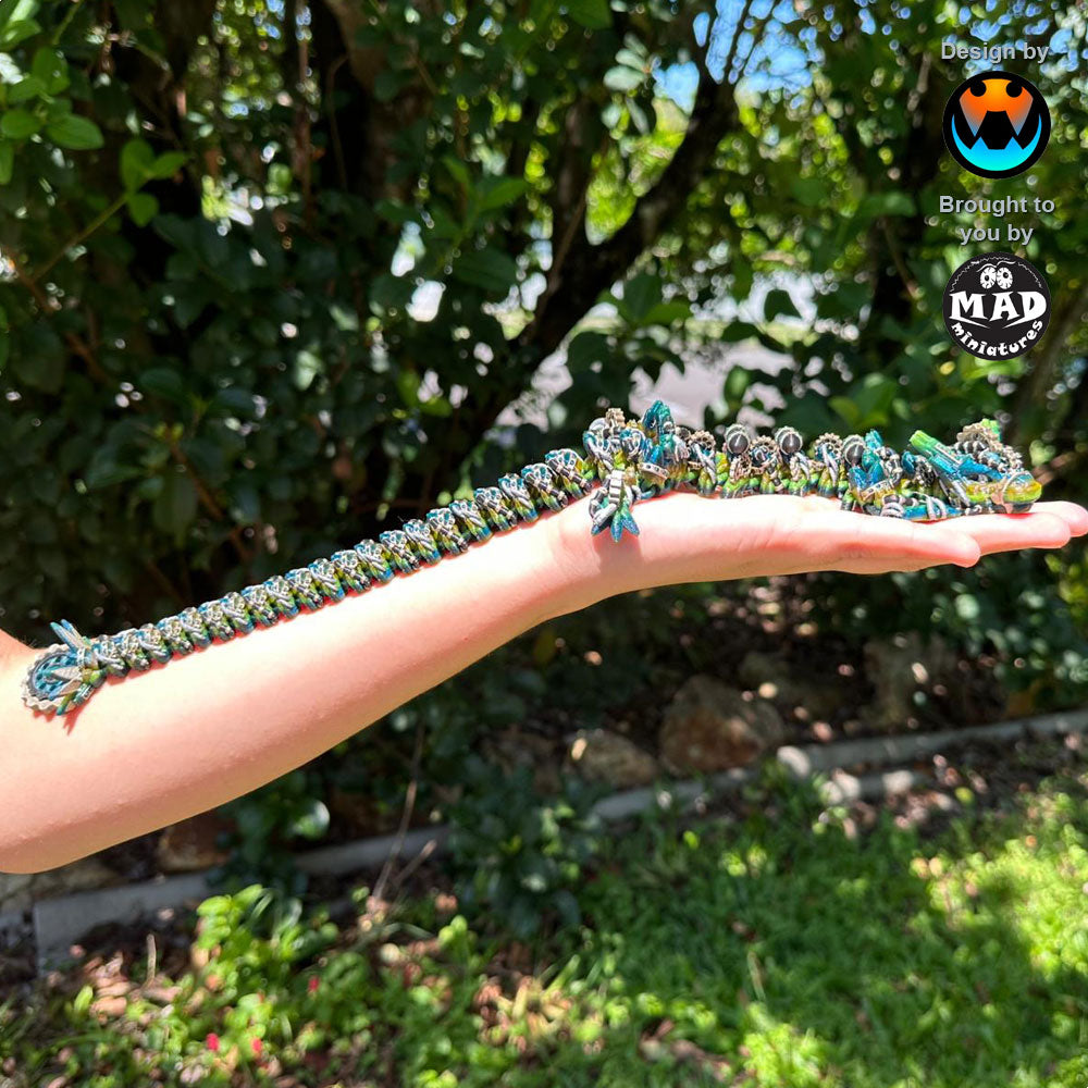 Medium-sized articulated steampunk dragon held by a person, showcasing its compact size and intricate detailing