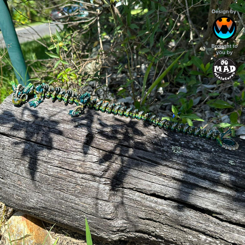 Medium-sized articulated steampunk dragon resting on a tree trunk, with visible gears and mechanical details