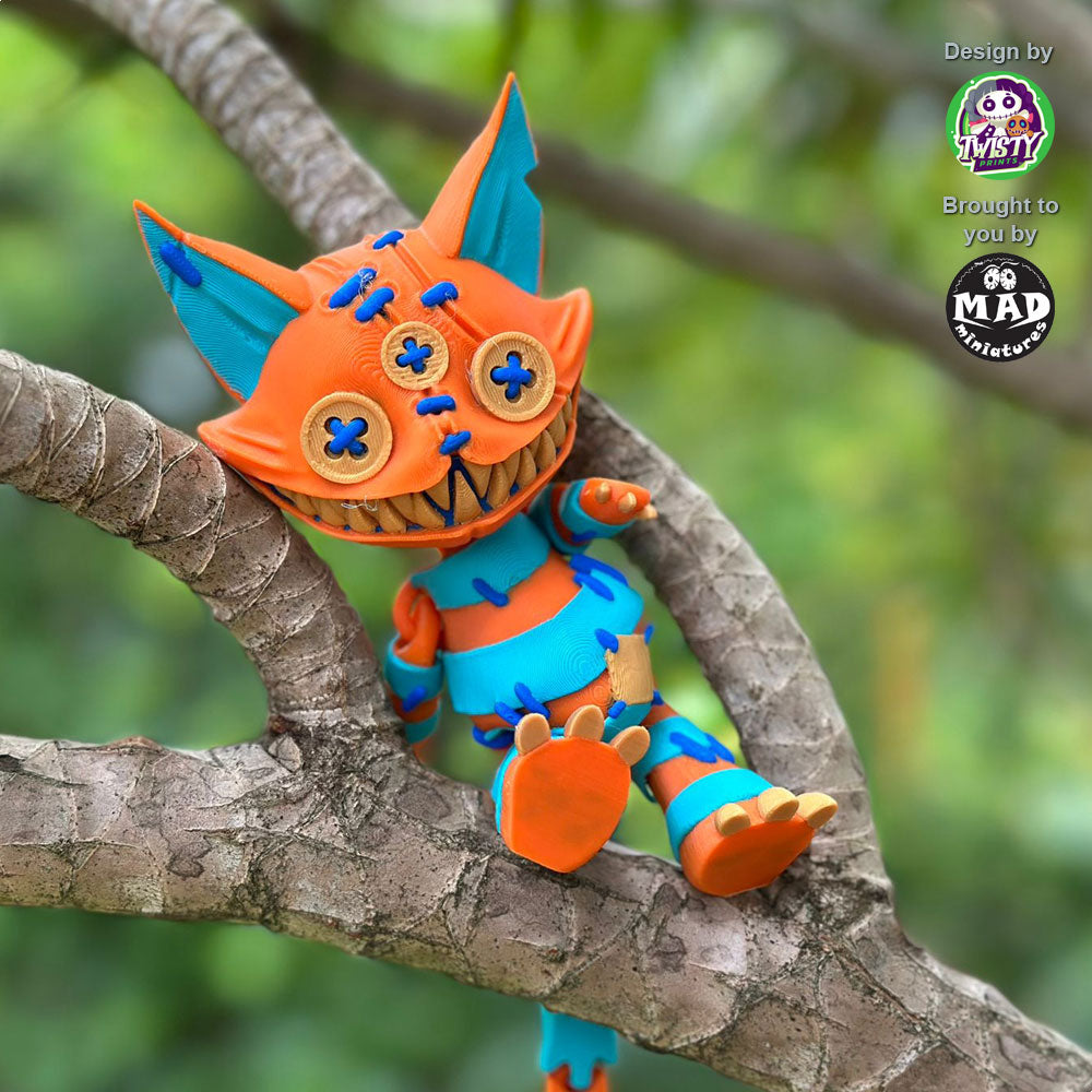 Close-up of Stuffed Cat sitting in a tree, focusing on her button eyes, stitched seams, and wide, toothy grin, with her tail out of sight.