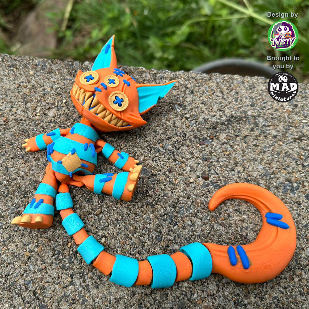tuffed Cat lying on top of a wall, stretching her legs, with her vibrant patchwork design and articulated limbs on full display.