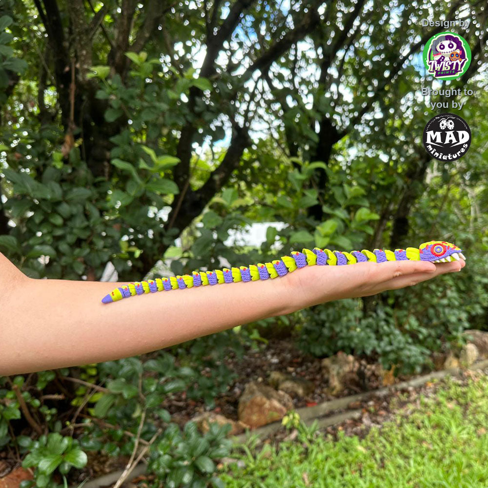 Small version of Stuffed Snake held by a person, illustrating its 340mm length and delightful, eerie design.