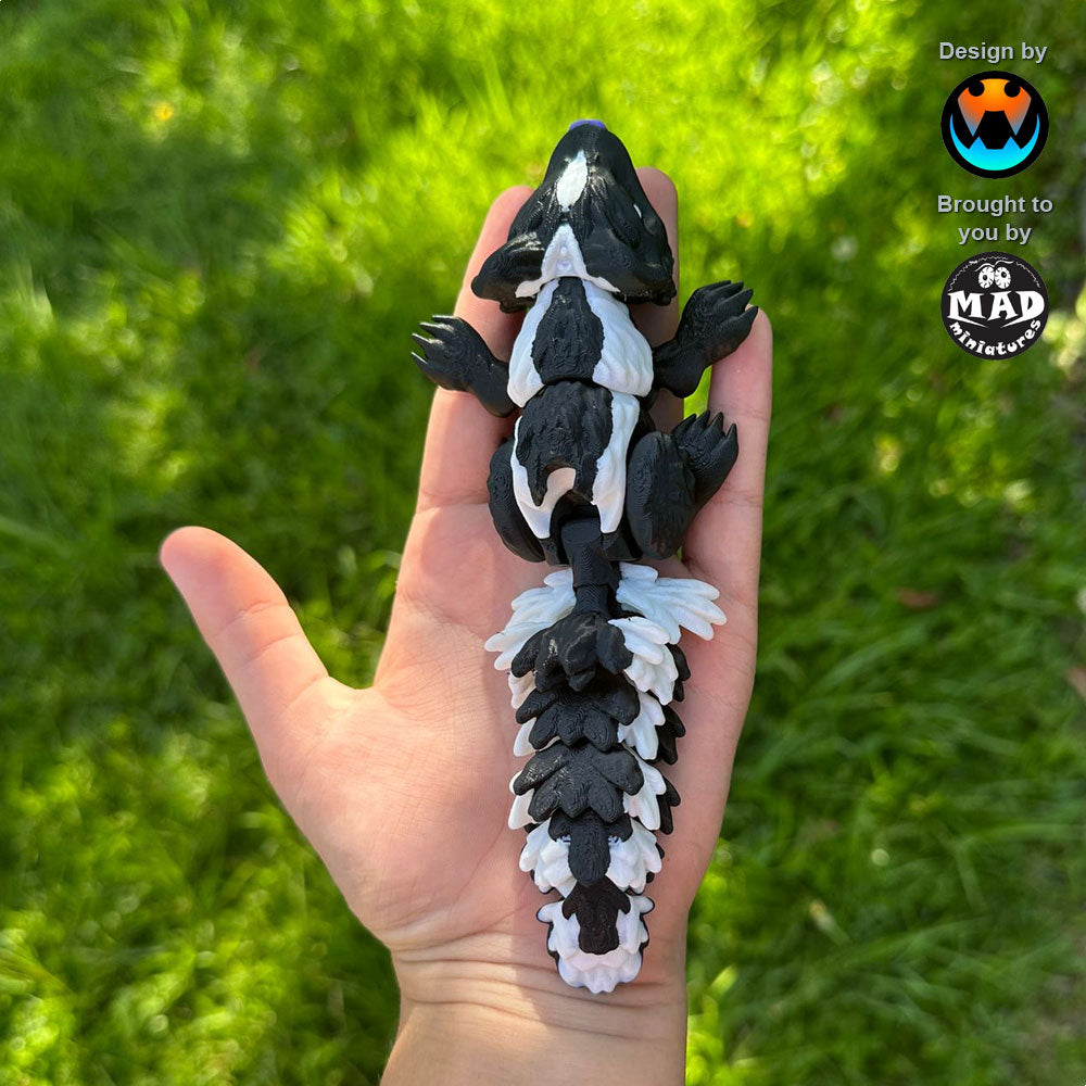 Sweetheart Skunk from Mad Miniatures, designed by Cinderwing (normal size, no rose) resting on a hand. Fully articulated and super cute.
