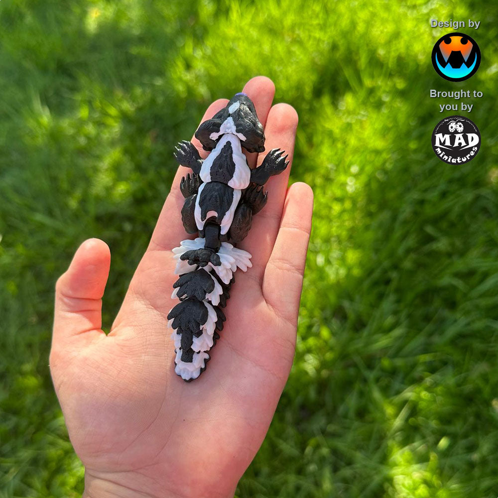 Sweetheart Skunk from Mad Miniatures, designed by Cinderwing (small size, no rose) resting on a hand. Adorable and perfect for gifting or collecting.