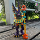 Articulated Anubis figure standing on a wooden deck, holding a staff
