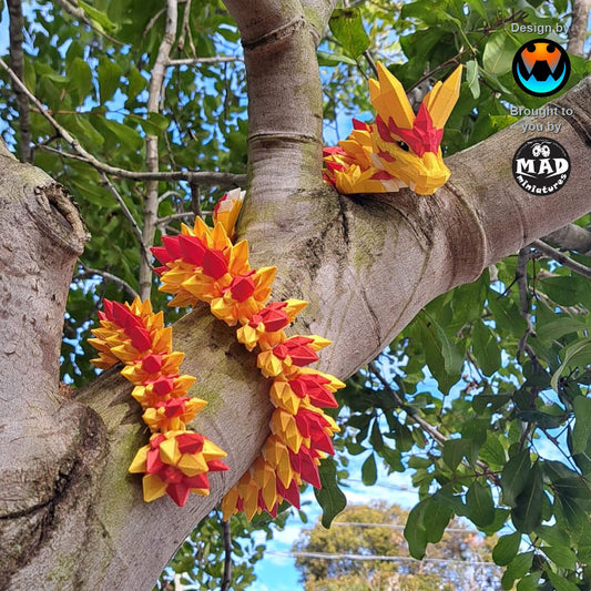 Golden Dragon of Wisdom – articulated 3D printed dragon in shimmering red and gold, wrapped around a tree branch – Mad Miniatures design