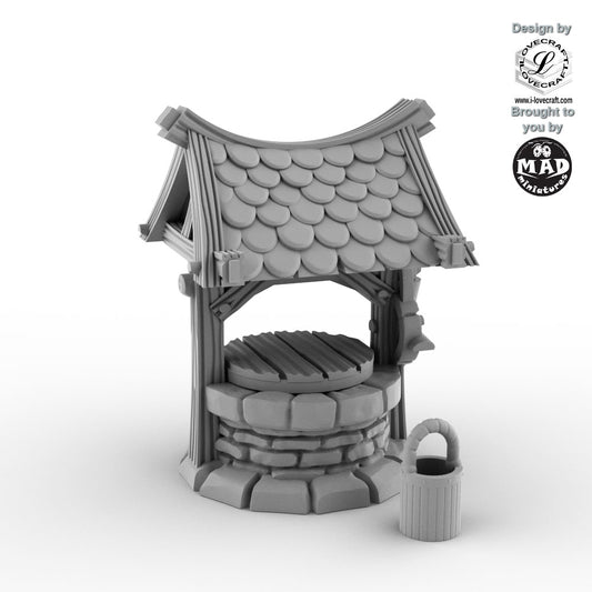 Rustic little fantasy well with shingled roof and bucket by Mad Miniatures