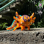 Articulated axolotl figure in bright orange with tribal markings

