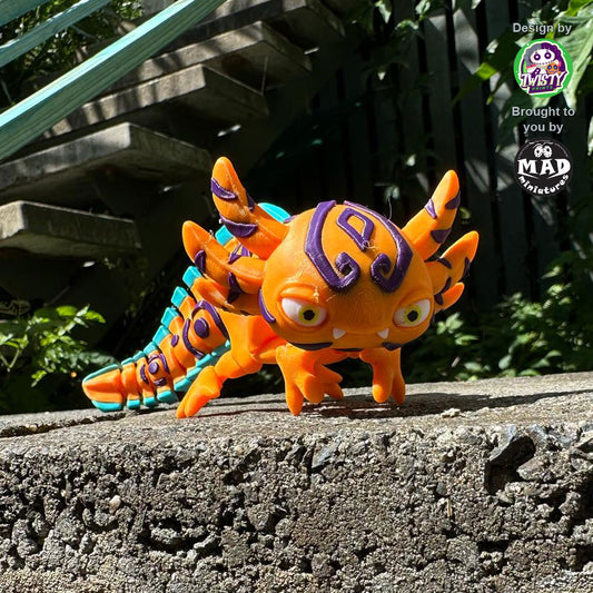 Articulated axolotl figure in bright orange with tribal markings

