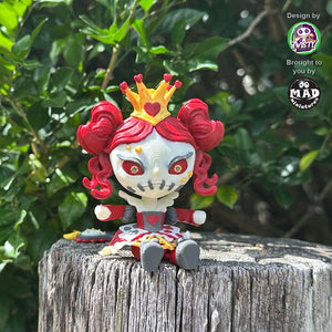 Queen of Hearts articulated figure sitting on a wooden post, featuring red curls, a golden crown, and a gothic fairytale design.