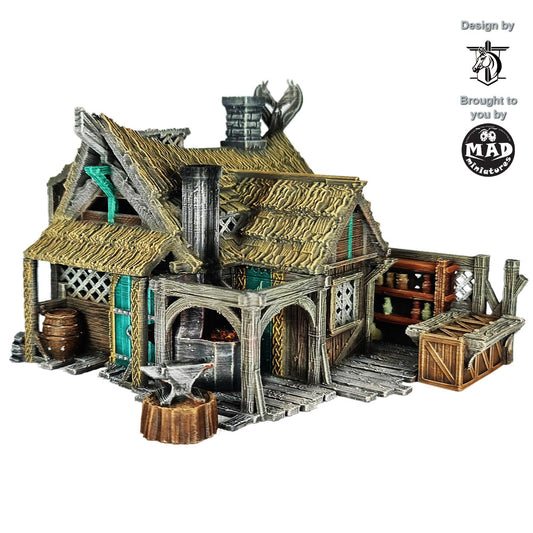 Painted 3D-printed Horseheim Blacksmith building with forge, thatched roof, and timber workshop – 32 mm terrain by Mad Miniatures.
