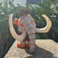 Mammoth with a tilted head, showcasing its humorous wide-eyed expression and orange features, perfect for adding whimsy to any collection.