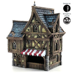 Fully painted Merchant's House tabletop terrain piece, featuring a three-story medieval building with intricate details, vibrant colors, and a quaint shopfront