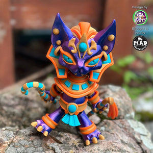 Pharaoh Cat in action, showing off her shimmering blue-purple coat, golden Egyptian attire, and vibrant staffs.