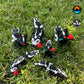 Six red Sweetheart Skunks from Mad Miniatures, designed by Cinderwing, sitting on grass, with and without roses, in small and normal sizes. Fully articulated and charming.
